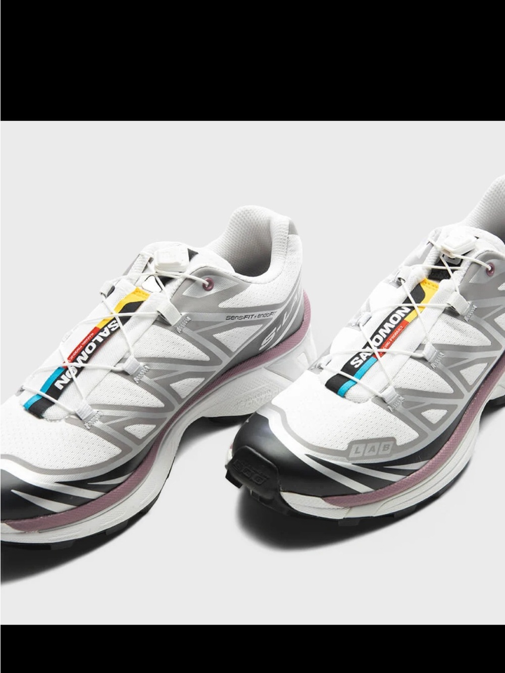 Salomon White Athletic Shoes with Pink and Black Accents